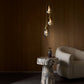Modern interior with a marble side table, decorative vase, and hanging pendant lights.
