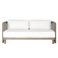A modern outdoor loveseat with a light gray weathered wood frame, white cushions, and black-and-white chevron woven side accents, shown against a solid white background.