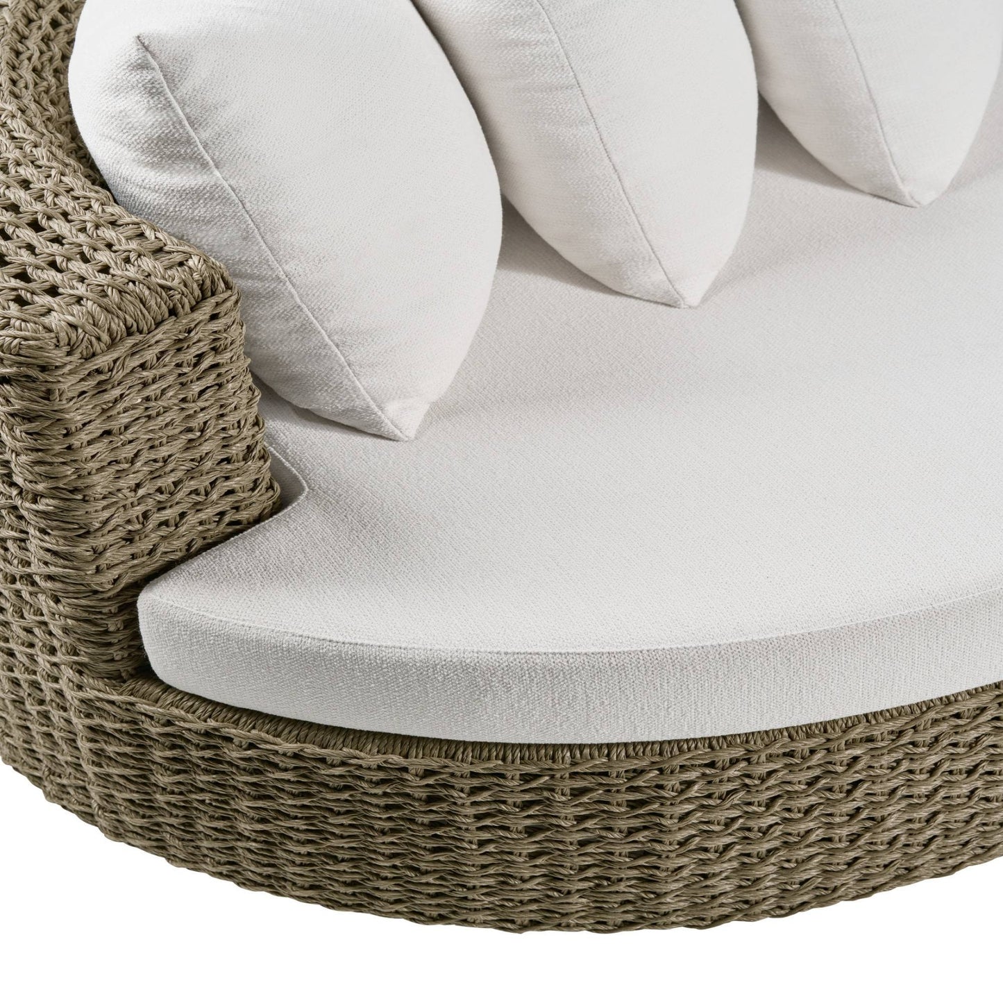 Round wicker chair with white cushions on a white background
