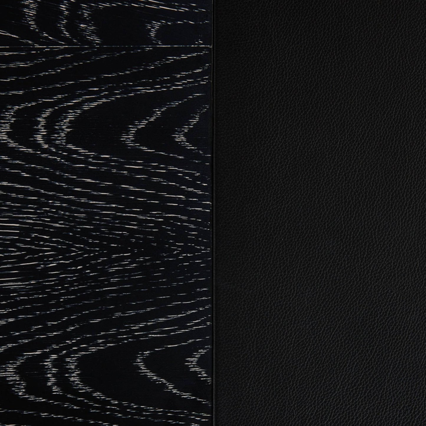 Close-up of a black textured material sample with a vertical split: left side shows a dark wood grain pattern, right side shows a smooth black pebbled texture.