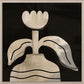 Abstract art piece with a stylized flower on a black background