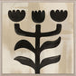 Abstract black floral design on a beige background