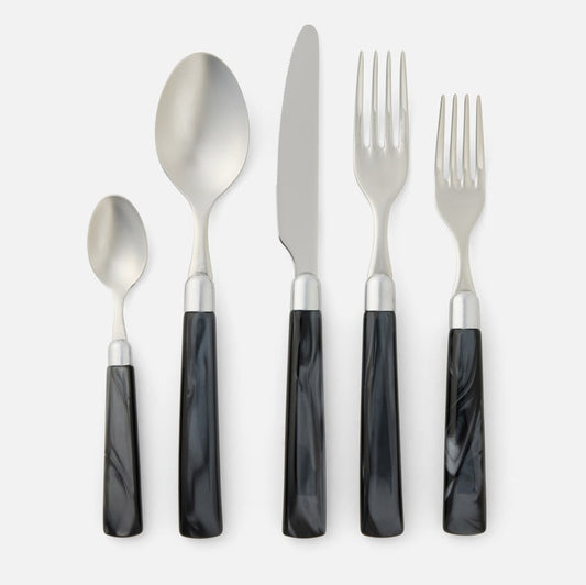 Set of silver cutlery with black handles on a white background