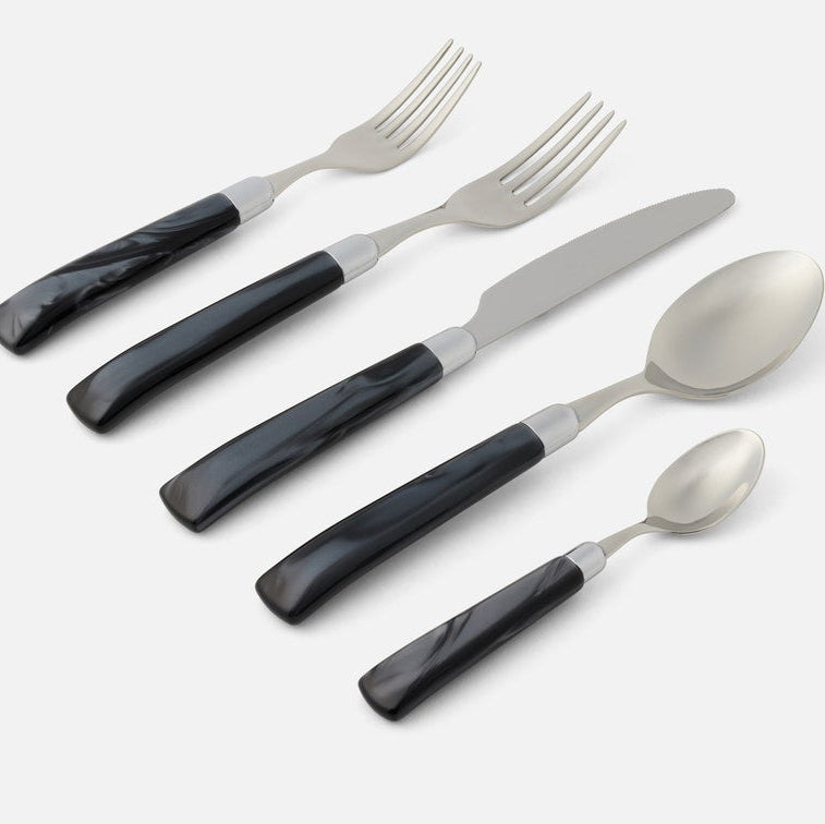 Set of silverware with black handles on a white background