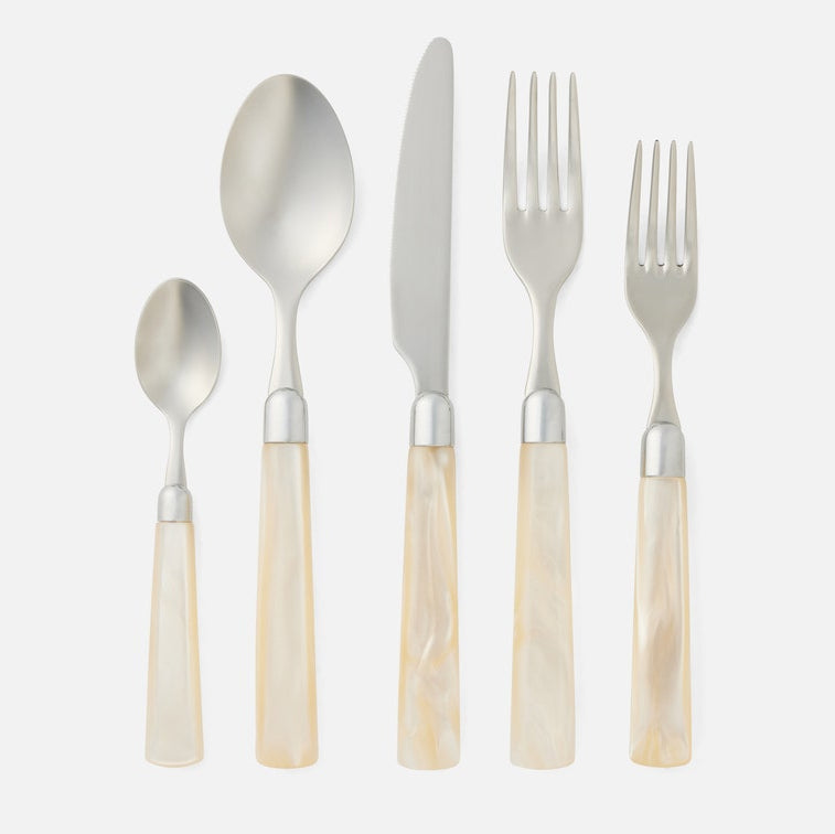 Set of silver cutlery with shell handles on a white background