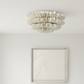 Ceiling light fixture in a minimalistic room with a framed picture on the wall.