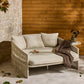 Beige outdoor sofa with cushions against a wooden wall.