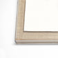 Close-up of a beige picture frame corner on a white background