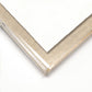 Close-up of a silver picture frame corner on a white background