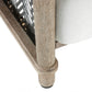Close-up of a wooden chair leg with a white cushioned seat on a white background