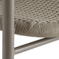 Close-up of a chair with woven seat and metal frame on a white background