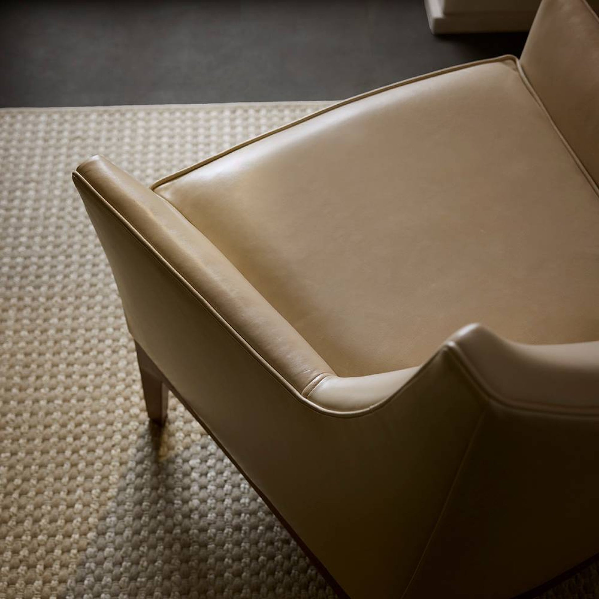Beige armchair on a textured carpet