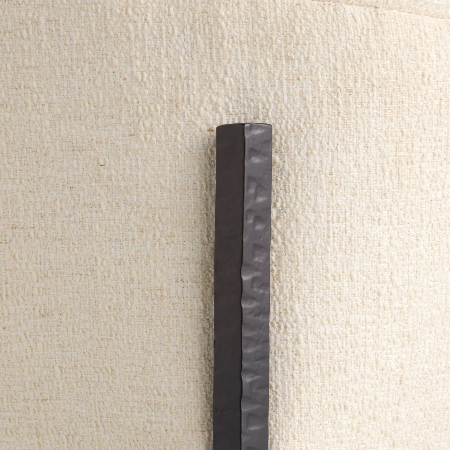 Black rectangular object on a beige textured background