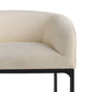 Close-up of a beige upholstered chair with a black metal frame on a white background