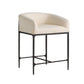 Beige cushioned chair with black metal frame on a white background