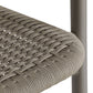 Close-up of a woven chair seat with a metal frame on a white background