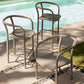 Three outdoor chairs by a poolside on a sunny day.