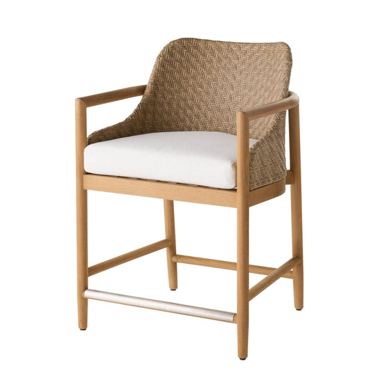 A modern outdoor barstool featuring a light natural wood frame, a woven wicker backrest, and a thick white seat cushion, shown against a plain white background.