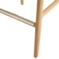 Close-up of a wooden chair leg on a white background