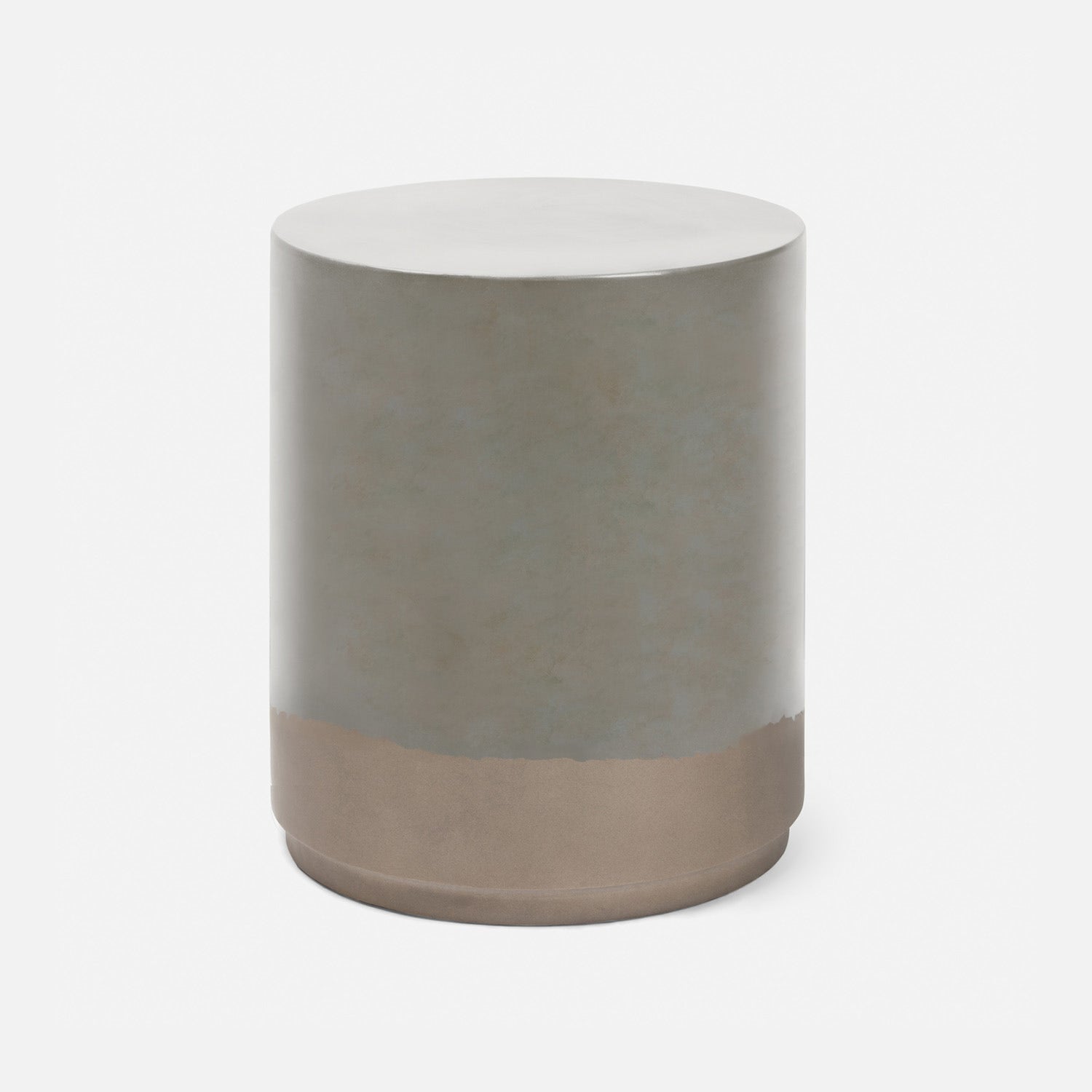 A modern cylindrical side table or stool with a matte metallic finish, featuring a silver-gray upper body and a warm bronze base, shown on a clean white background.