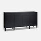 A modern black sideboard cabinet with three drawers on top, two doors in the center, and four tapered legs, accented with small brass knobs, shown on a light gray background.