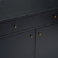 Close-up of a black wooden cabinet with a textured finish and small round gold-toned drawer pulls, showing part of the top surface and front doors.
