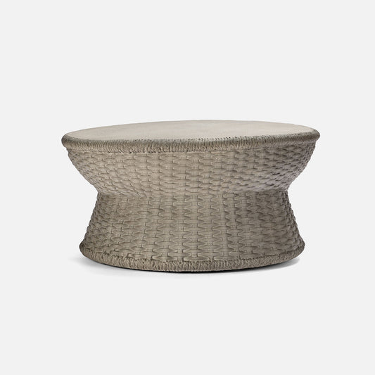 Woven coffee table with a textured surface on a white background