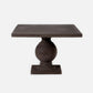 A dark brown wooden pedestal table with a square top, a rounded central base, and a rectangular footplate, shown against a plain light gray background.
