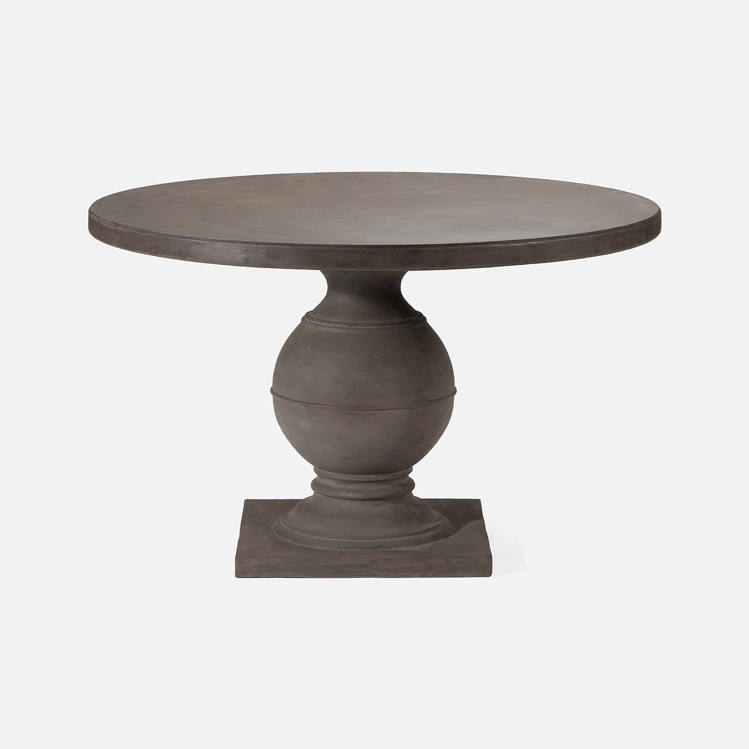 Round pedestal table with a textured surface on a white background
