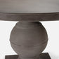 A close-up of a round dining table featuring a dark gray wood top and a matching round pedestal base with a matte finish, set against a plain white background.