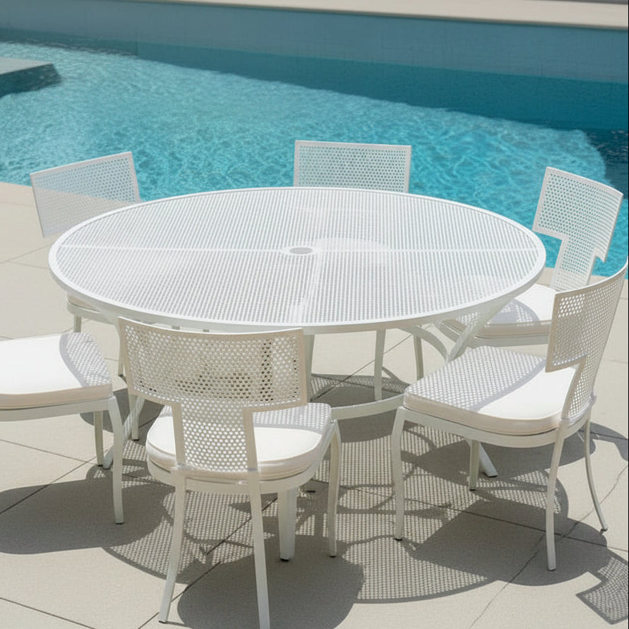 White outdoor dining table and chairs by a pool