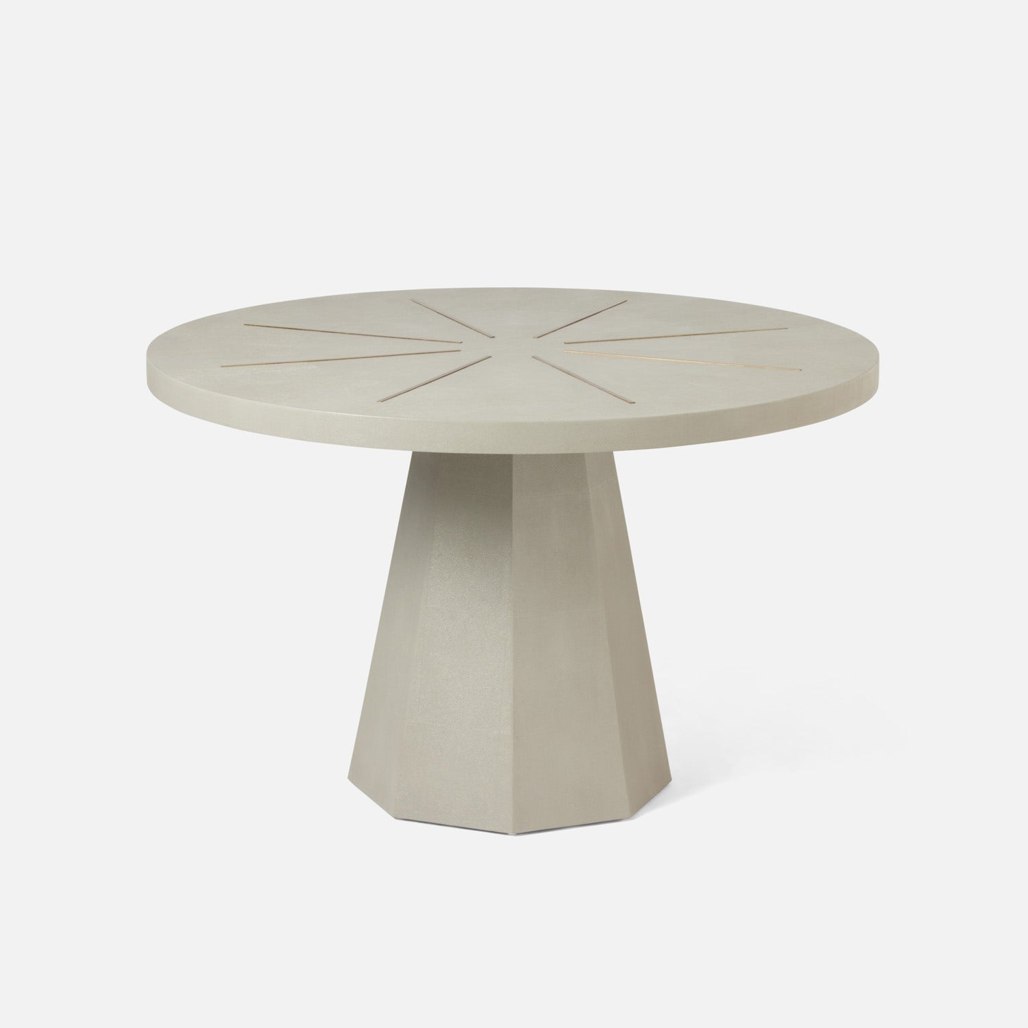 Round beige table with a geometric base on a white background