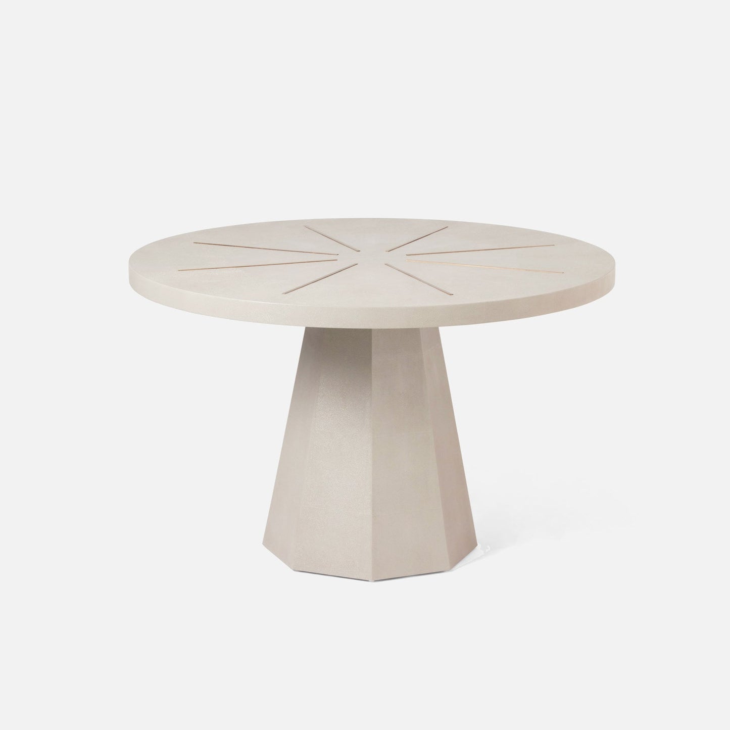 Round beige table with a geometric base on a white background