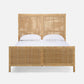 Wicker bed with white bedding on a white background