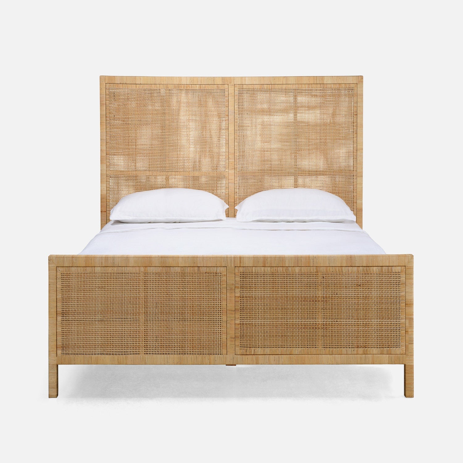 Wicker bed with white bedding on a white background