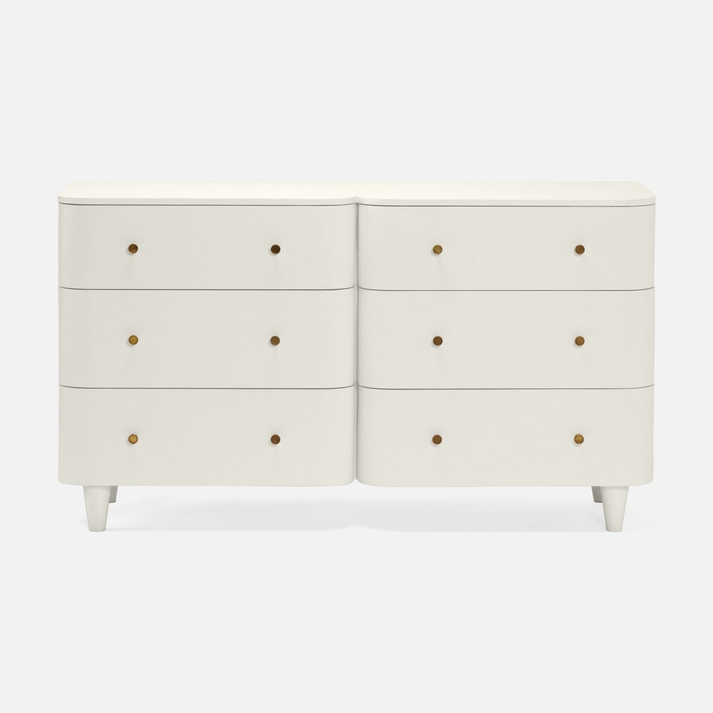 An off-white double dresser with six drawers, featuring small round brass pull knobs and tapered legs, shown against a light gray background.