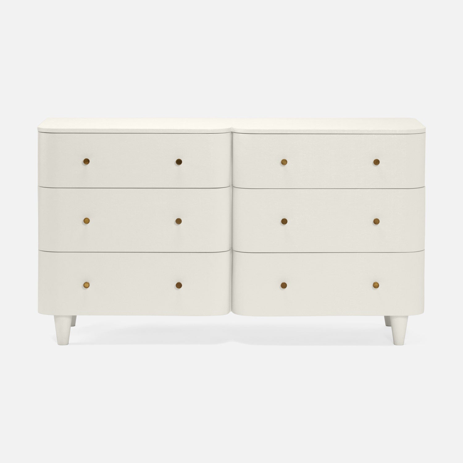 An off-white double dresser with six drawers, featuring small round brass pull knobs and tapered legs, shown against a light gray background.