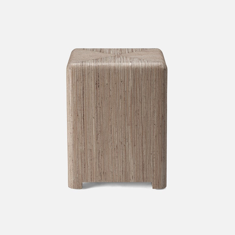 Square wooden stool with a textured surface on a white background