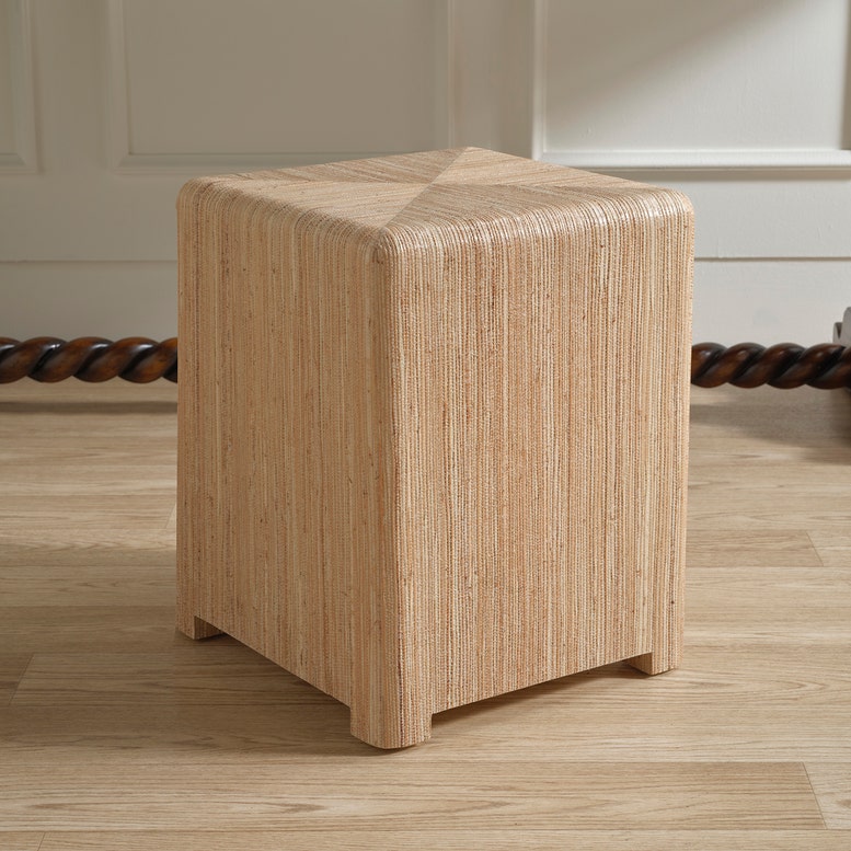 Wooden cube stool on a wooden floor with a neutral background