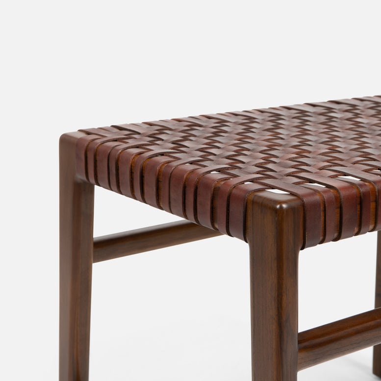 Wooden bench with woven seat on a white background
