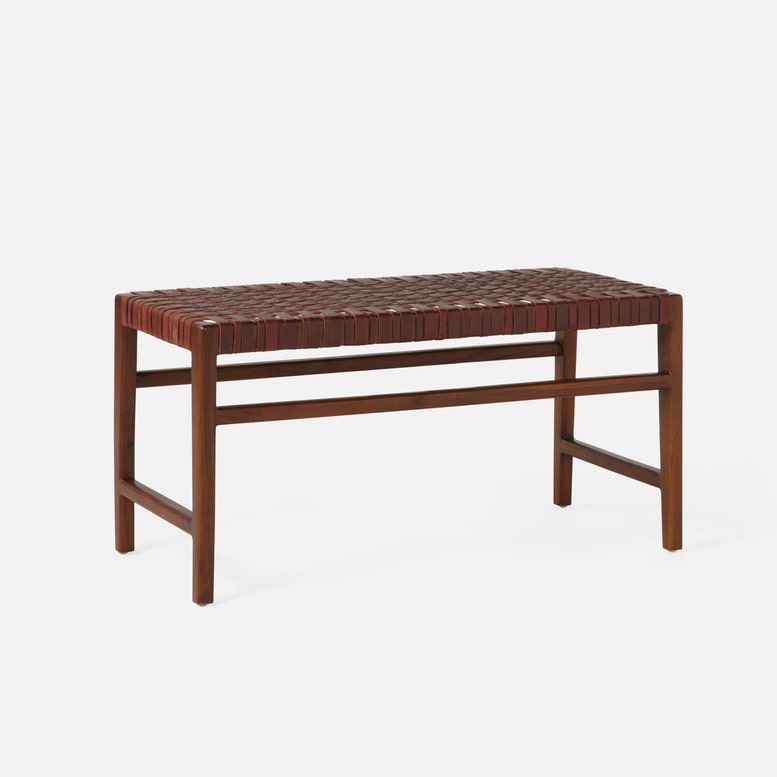 Wooden bench with woven top on a white background