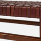 Close-up of a brown leather bench with woven pattern on a white background