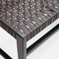 Close-up of a woven chair seat with metal frame on a white background