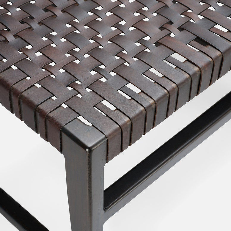Close-up of a woven chair seat with metal frame on a white background