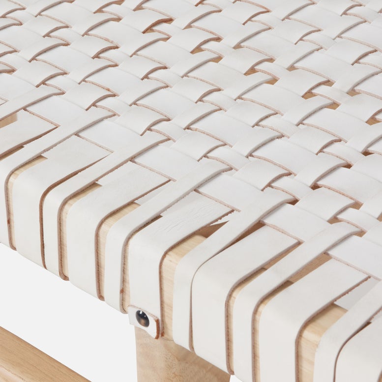Close-up of a woven white cushion on a chair with a blurred background