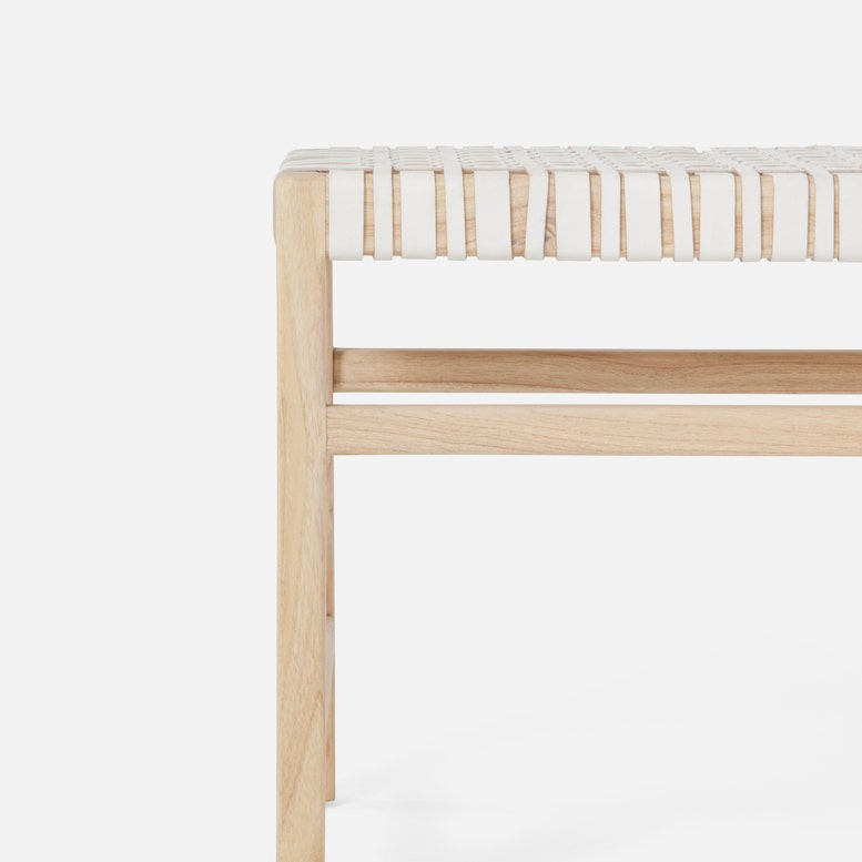 Wooden stool with woven seat on a white background