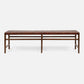 Wooden bench with woven top on a white background