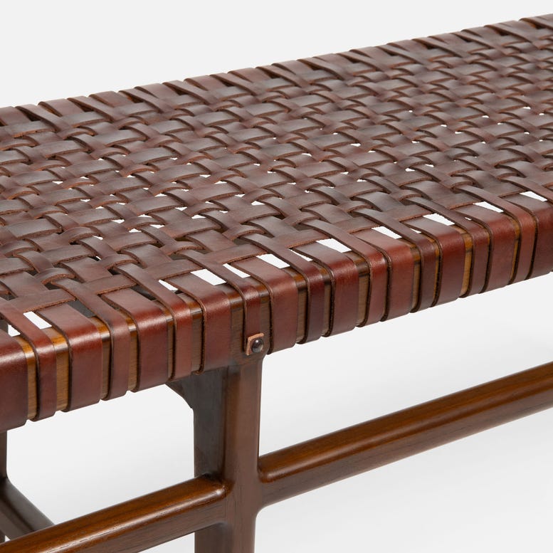 Woven brown leather bench on a white background