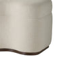 Close-up of a textured beige ottoman with a brown trim on a white background