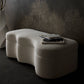 Modern white ottoman with a book on a dark background